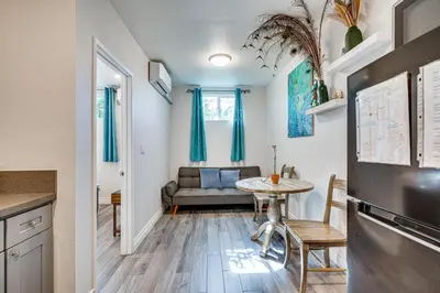 a living room with a table and a couch at Explore Shops, Eats and Entertainment! Pasadena Apt in Pasadena