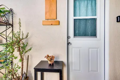 a white door in a room with a table at Explore Shops, Eats and Entertainment! Pasadena Apt in Pasadena