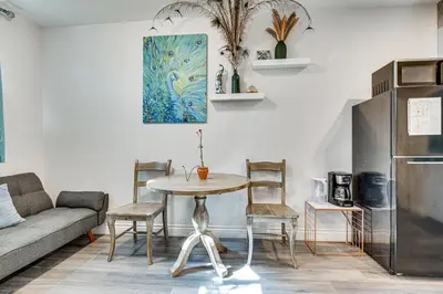 a living room with a table and a couch at Explore Shops, Eats and Entertainment! Pasadena Apt in Pasadena