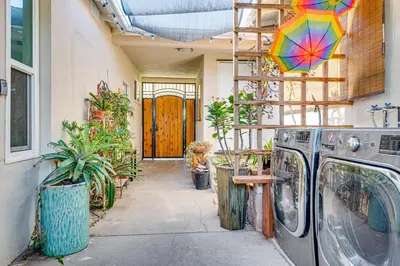 a washing machine in a house with a colorful umbrella at Explore Shops, Eats and Entertainment! Pasadena Apt in Pasadena