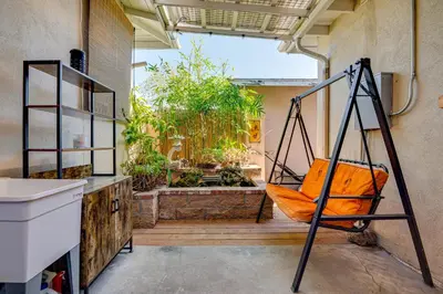 a porch with a swing in a room with a garden at 4 Mi to Old Pasadena! Well-Appointed Studio Stay in Pasadena