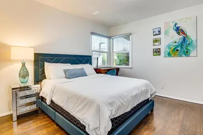 a bedroom with a large bed and a window at Peacock House Sanctuary 4 Mi to Old Pasadena! in Pasadena