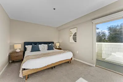 a bedroom with a bed and a large window at Vertical Blue Bi-Level Sanctuary with Pacific Vistas in Los Angeles