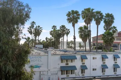 a hotel with palm trees in the background at Vertical Blue Bi-Level Sanctuary with Pacific Vistas in Los Angeles