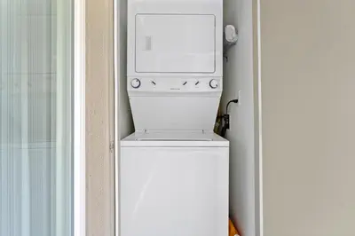 a microwave sitting on top of a white refrigerator at The Glass Anchor - 2 Bed Front-Row Marina Suite in Los Angeles