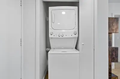 a computer sitting on top of a refrigerator in a closet at Urban Tide - A Designer Escape Overlooking the Docks in Los Angeles