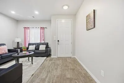 a living room with a couch and a table at Serenity House in Bakersfield