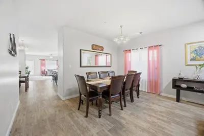 a dining room with a table and chairs at Serenity House in Bakersfield