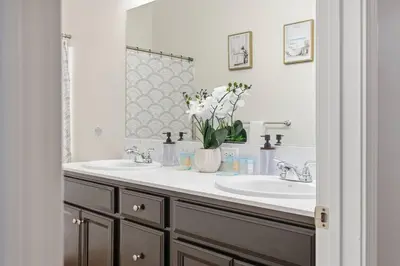 a bathroom with two sinks and a mirror at Serenity House in Bakersfield