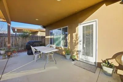 a patio with a white table and chairs on it at Serenity House in Bakersfield