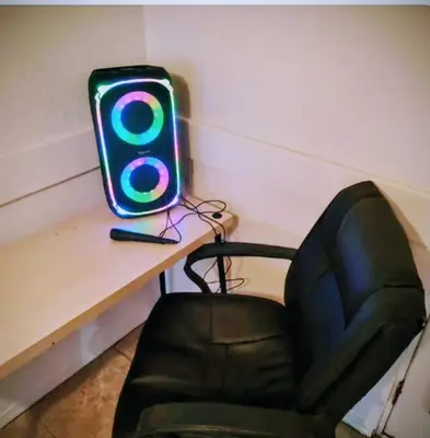 a computer monitor sitting on a desk next to a chair at The Joshua House in Boron