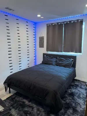 a bedroom with a bed in a room with blue lights at Paradise in LA near LAX and SoFi Stadium in Los Angeles