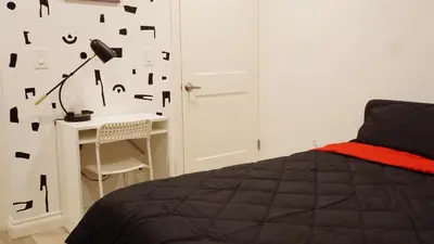 a bedroom with a bed and a desk with a lamp at Paradise in LA near LAX and SoFi Stadium in Los Angeles