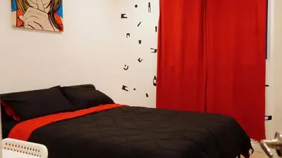 a bedroom with a bed and a red curtain at Paradise in LA near LAX and SoFi Stadium in Los Angeles
