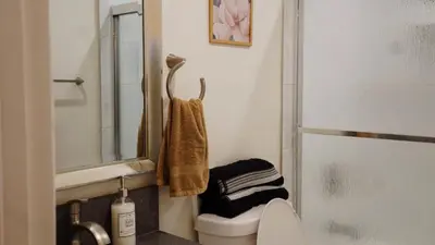 a bathroom with a toilet and a sink and a mirror at Paradise in LA near LAX and SoFi Stadium in Los Angeles