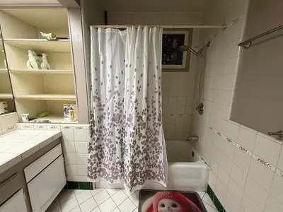 a bathroom with a shower with a shower curtain at Citrus Loft Room B - Quiet and Convenience Female Only in Covina