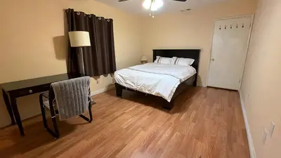 a bedroom with a bed and a table with a chair at Citrus Loft Room B - Quiet and Convenience Female Only in Covina