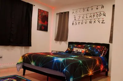 a bedroom with a bed with lights on it at Themed Townhouse Retreat Near LAX and Sofi in Los Angeles