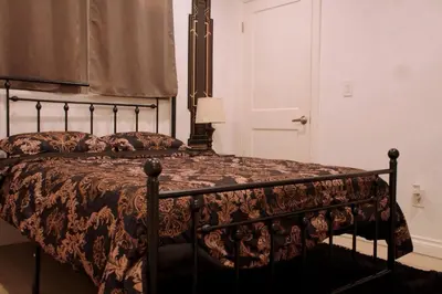 a bedroom with a bed with a black frame at Themed Townhouse Retreat Near LAX and Sofi in Los Angeles