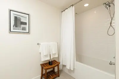 a white bathroom with a tub and a shower at Platinum Space in WeHo in Los Angeles