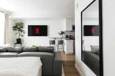 a living room with a couch and a mirror at Platinum Space in WeHo in Los Angeles