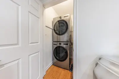 a laundry room with a washer and dryer next to a door at Bright 2 Bedroom Home in the Heart of Santa Monica in Los Angeles