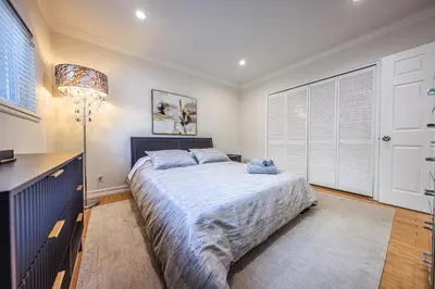 a bedroom with a large bed and a lamp at Bright 2 Bedroom Home in the Heart of Santa Monica in Los Angeles