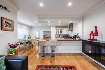 a kitchen and living room with a table and chairs at Bright 2 Bedroom Home in the Heart of Santa Monica in Los Angeles