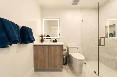 a bathroom with a toilet and a sink and a shower at The Velvet Coast - Grand 3BR Artistic Haven in Los Angeles