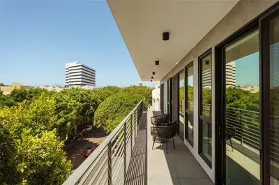 a balcony with a view of a city at The Velvet Coast - Grand 3BR Artistic Haven in Los Angeles