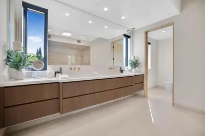a bathroom with a large tub and a large mirror at Amestoy Modern in Los Angeles