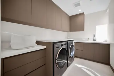a kitchen with a washer and dryer in it at Amestoy Modern in Los Angeles