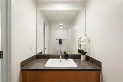 a bathroom with a sink and a mirror at Ocean's Edge 2BR Penthouse - Infinite Blue Views in Los Angeles