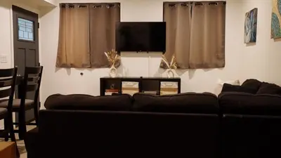 a living room with a couch and a flat screen tv at Pop Art Themed Bedroom in House-Shared Bathroom-Shared Living Room & Kitchen in Los Angeles