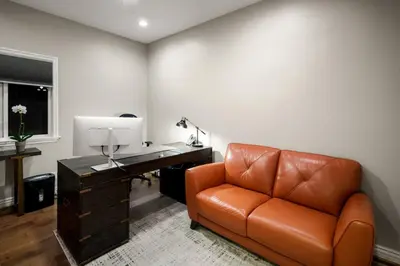 an office with a desk and a leather chair at Sherman Oaks Home w Pool, Spa and Outdoor Kitchen in Los Angeles