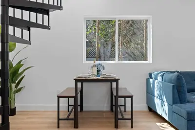 a living room with a table and a blue couch at New Listing Iconic Venice Living by Colby & Conrad in Los Angeles