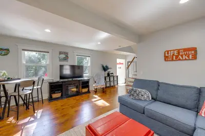 a living room with a couch and a table at Walk to Lake Arrowhead Village Bright Gem with Deck in Lake Arrowhead