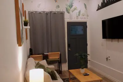 a living room with a couch and a table and a door at The Sunset Gathering in Los Angeles