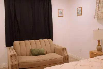 a living room with a couch and a chair at The Sunset Gathering in Los Angeles