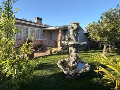 a stone fountain in the yard of a house at Guest house close to Universal Studios in Sun Valley