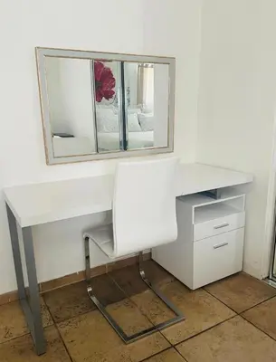 a white desk with a mirror and a chair at Guest house close to Universal Studios in Sun Valley