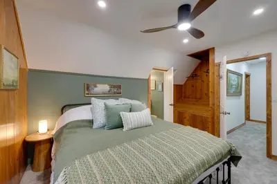 a bedroom with a bed and a ceiling fan at 1 Mi to Lake Arrowhead! All-Season Family Getaway in Lake Arrowhead