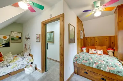 a bedroom with two beds and a ceiling fan at 1 Mi to Lake Arrowhead! All-Season Family Getaway in Lake Arrowhead