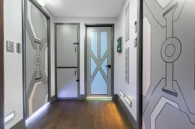 a hallway with a door with a painting on the wall at Star Wars Retreat by OC Adventure Homes in Garden Grove