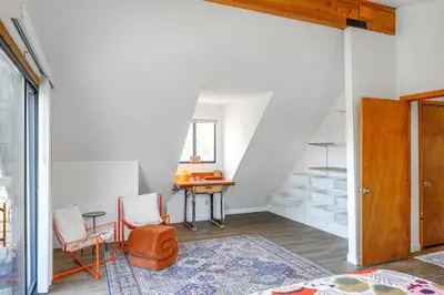 an attic room with a table and chairs and a desk at Mtn Views Near Hiking Pine Mountain Club Getaway! in Pine Mountain Club