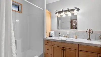 a bathroom with a sink and a mirror at Holiday Lake Cabin by AvantStay Large Deck Cozy Fireplace Near Arrowhead Village in Lake Arrowhead