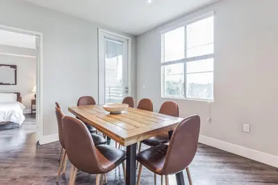 a dining room with a wooden table and chairs at 3BR 2BTH Santa Monica Apartment - Pool, Balcony, Near LAX in Los Angeles