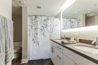 a bathroom with two sinks and a shower at 3BR 2BTH Santa Monica Apartment - Pool, Balcony, Near LAX in Los Angeles