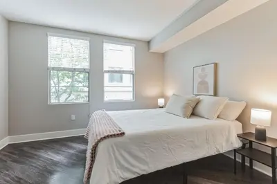 a bedroom with a large bed and two windows at 3BR 2BTH Santa Monica Apartment - Pool, Balcony, Near LAX in Los Angeles