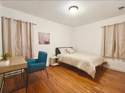 a bedroom with a bed and a blue chair at Spacious 3BR House Culver City Santa Monica & West LA in Los Angeles